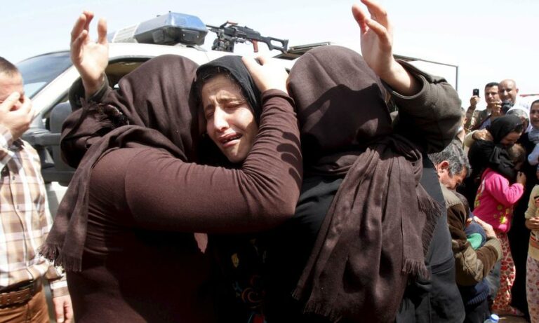 Members of the minority Yazidi sect who were newly released hug each other on the outskirts of Kirkuk April 8, 2015. More than 200 elderly and infirm Yazidis were freed on Wednesday by Islamic State militants who had been holding them captive since overru