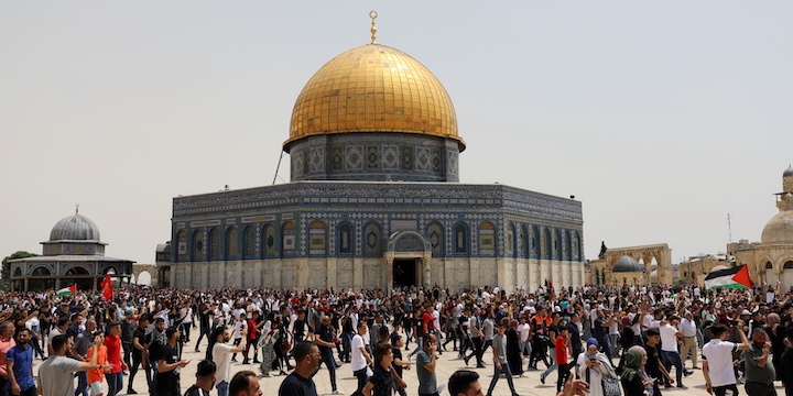 Palestinians walk at the compound that houses Al-Aqsa Mosque in Jerusalem’s Old City